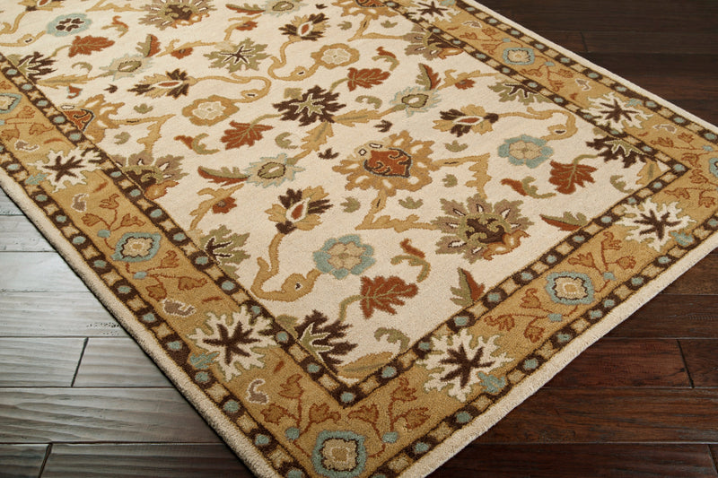 Venus Wheat hand-tufted wool rug with beige, terra cotta, and olive floral patterns on dark wood floor.