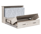 Light gray wood Mission cabinet Murphy bed opening to reveal a folded mattress and storage drawer.