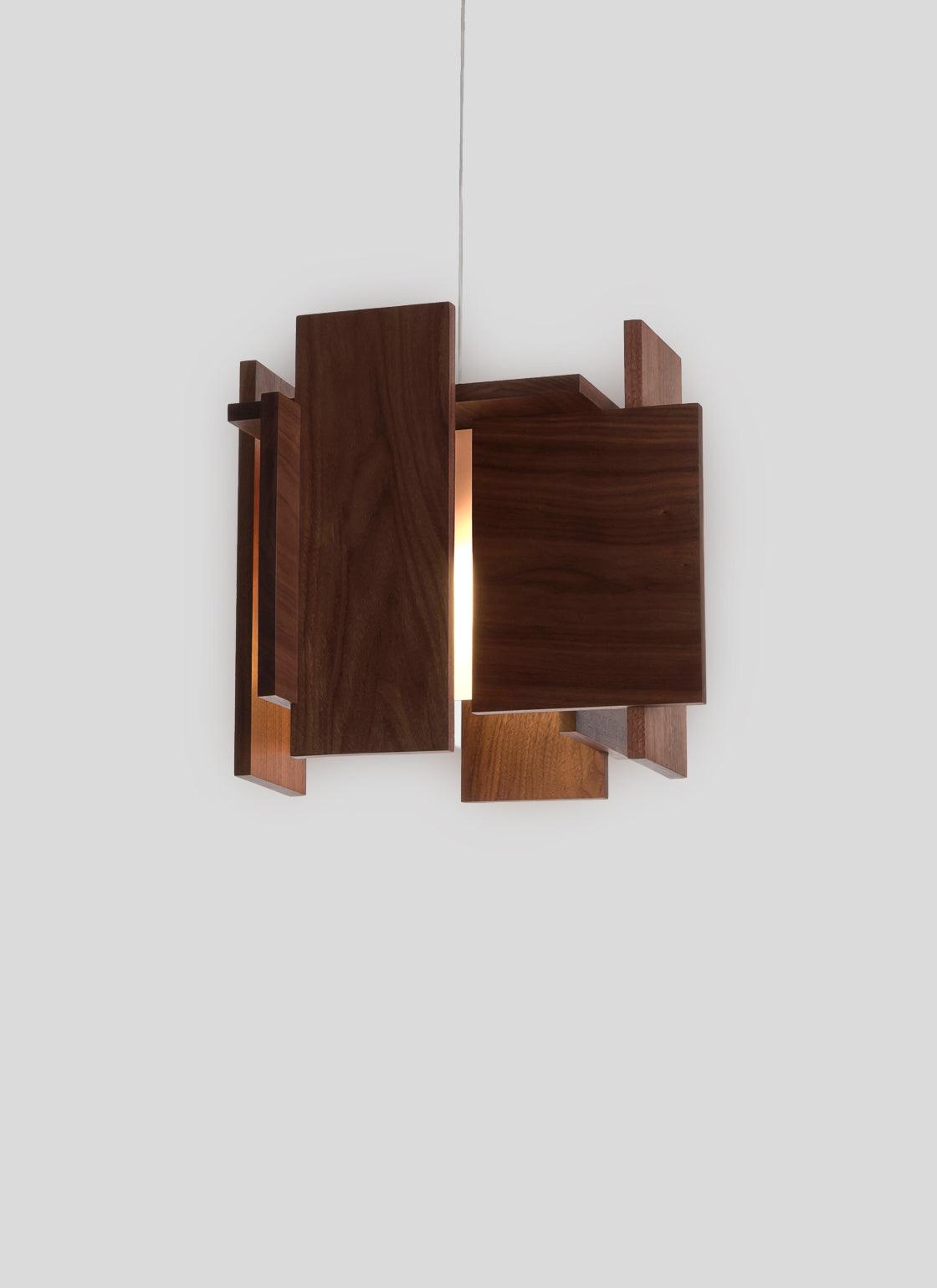 Abeo Pendant light with dark wood panels and warm glowing LED light.