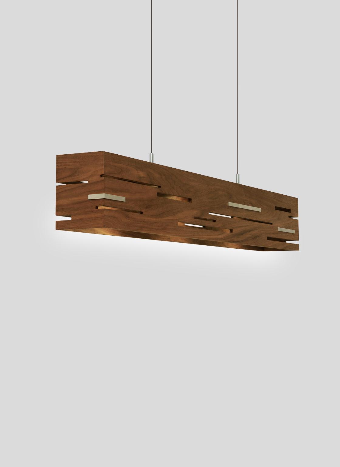 Aeris linear pendant chandelier in walnut wood with glowing geometric cutouts