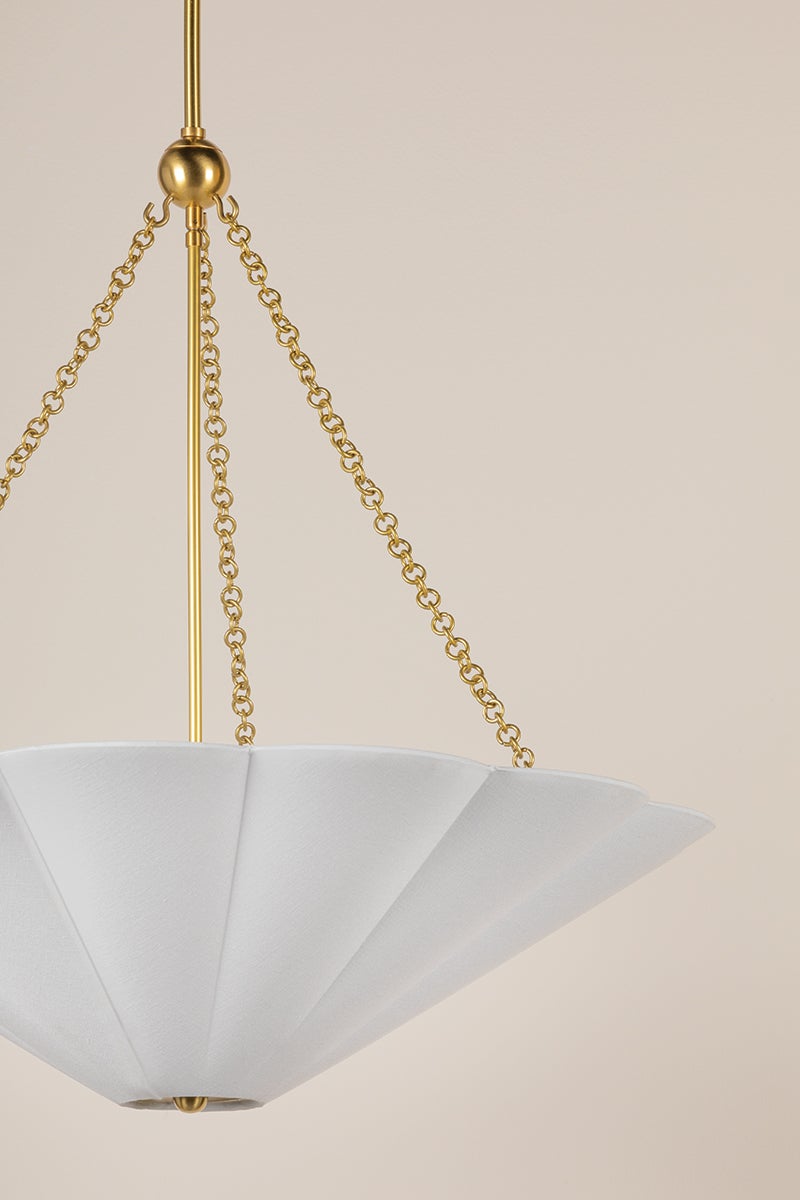 Alana pendant light featuring a white scalloped linen shade and aged brass chain accents.