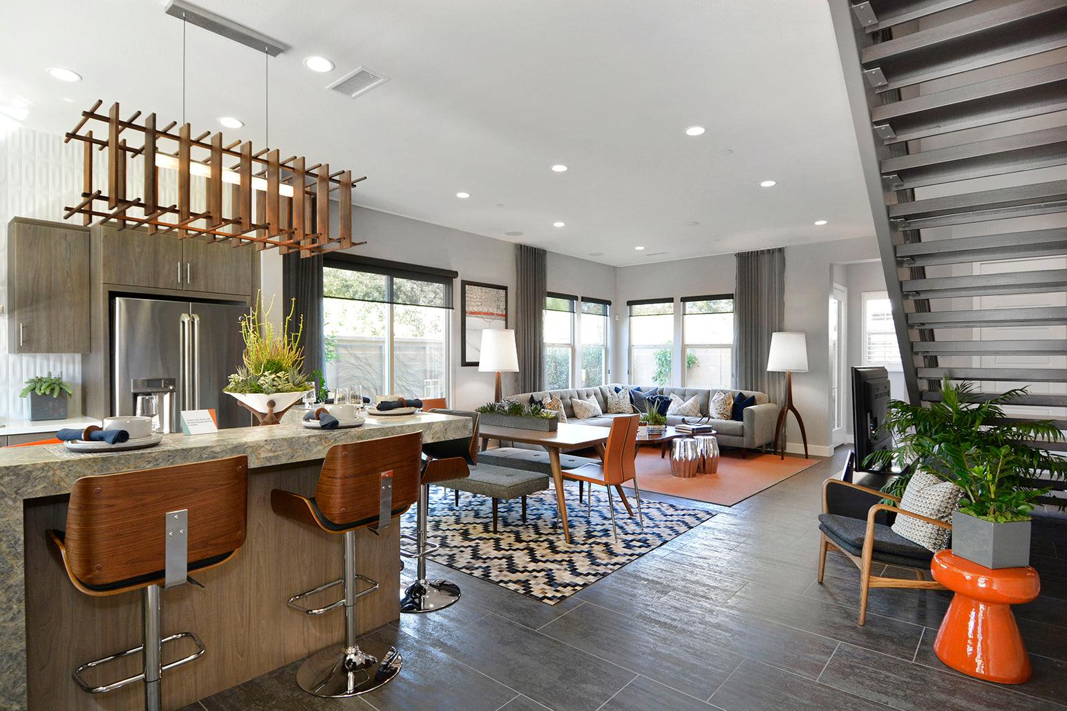 Arca walnut linear pendant chandelier hanging over a modern kitchen island.
