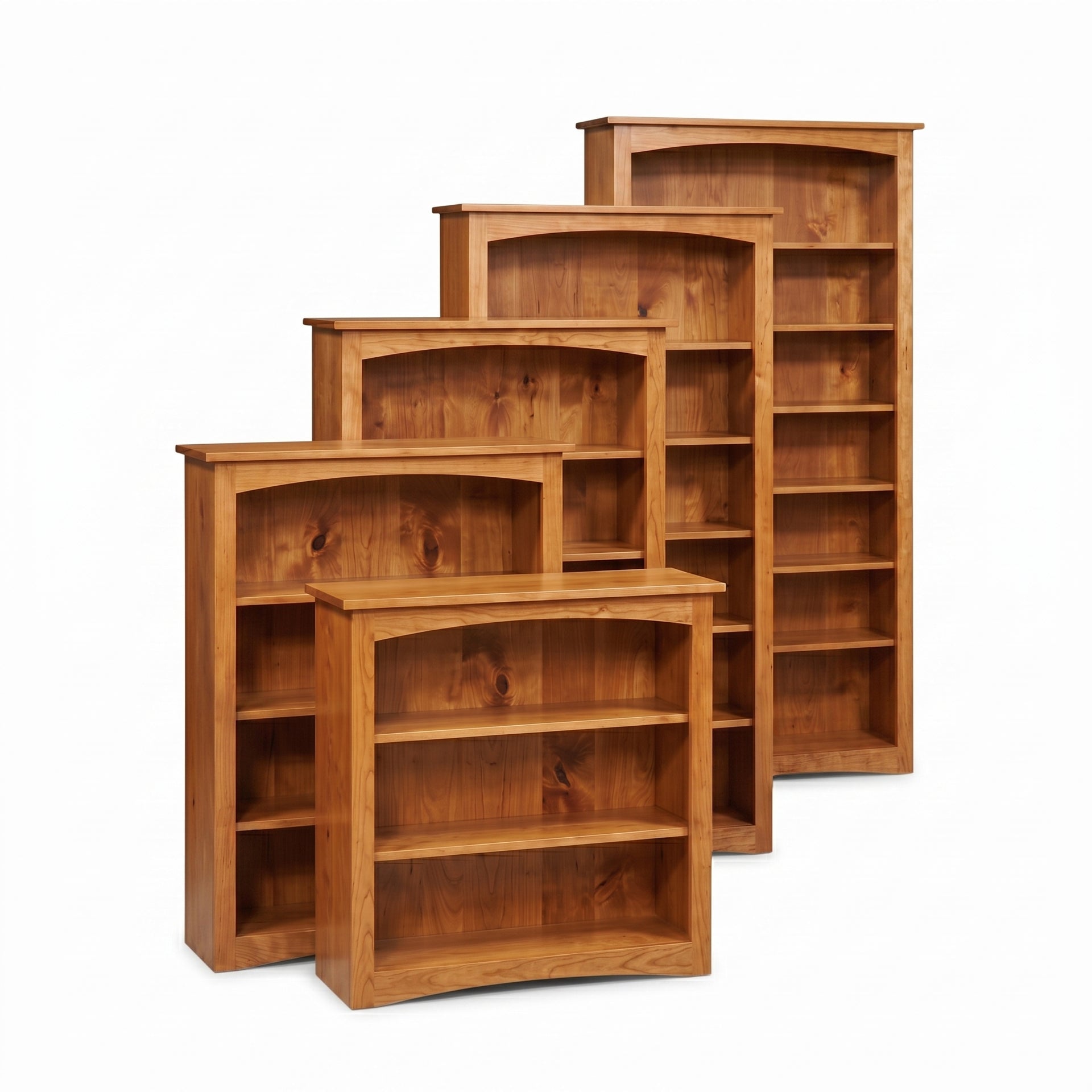 Five cherry wood Arch Bookcases in various heights, from short to tall, with arched tops.