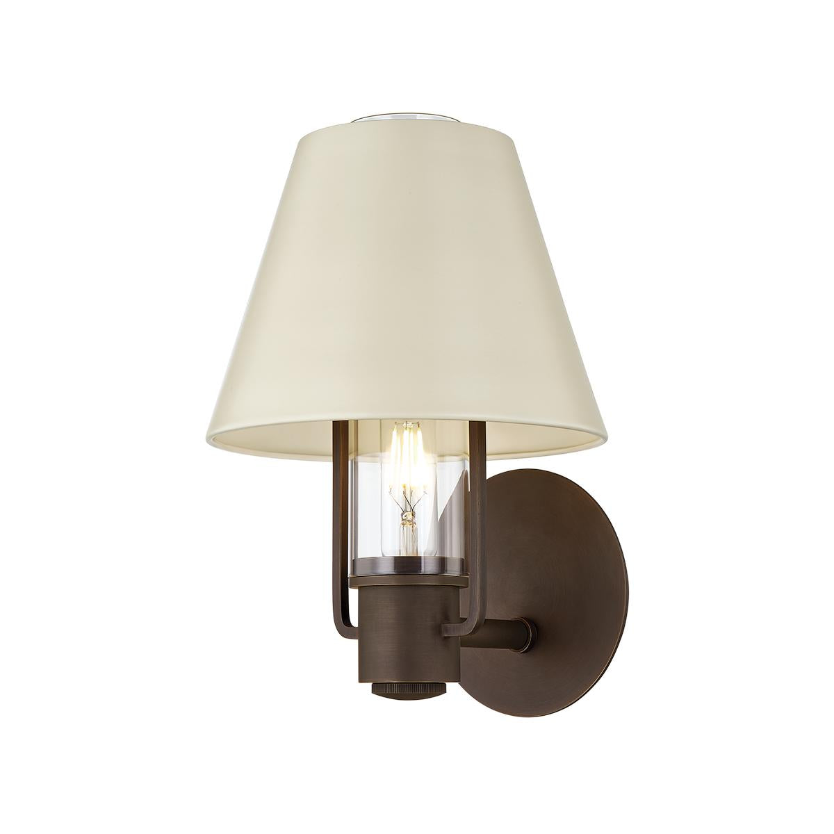 Kindle wall sconce in bronze with a tapered soft sand shade and clear glass housing.