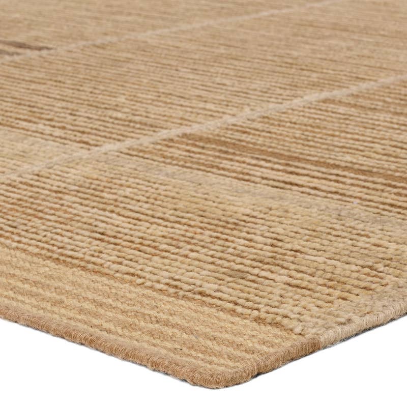 Bezem hand-knotted wool rug in beige with a textured, ribbed geometric pattern.