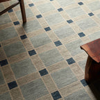 Cera Tiles hand-knotted wool rug with a blue and beige geometric plaid pattern.