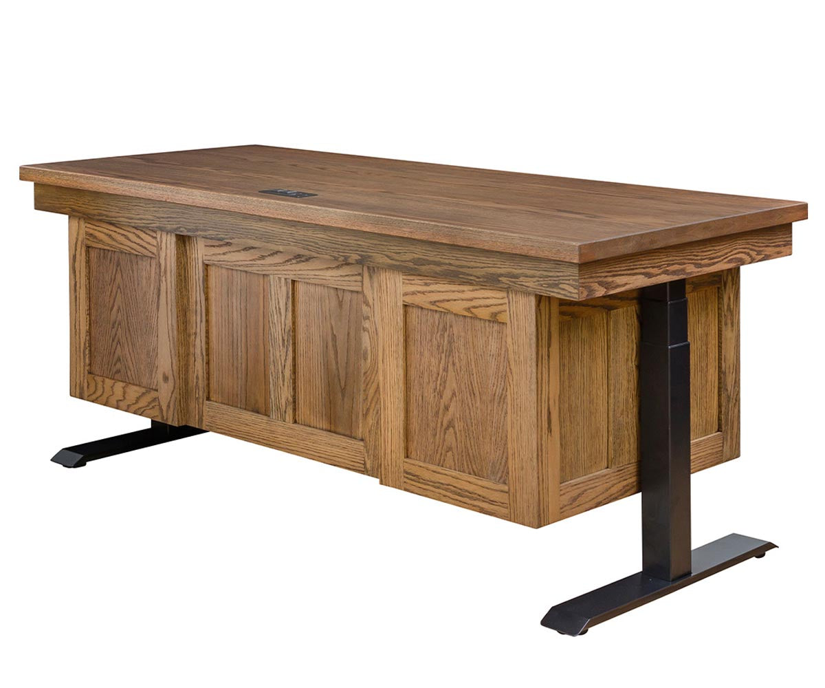 Adjustable height executive desk in brown oak wood with black metal lift legs.