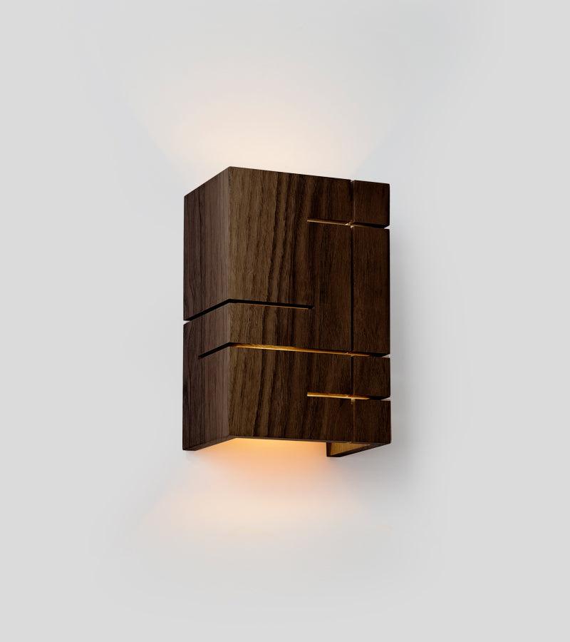 Claudo walnut wood sconce with geometric cutouts and warm LED light.