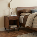 Bergen midcentury 1-drawer nightstand in clove on maple wood next to a bed