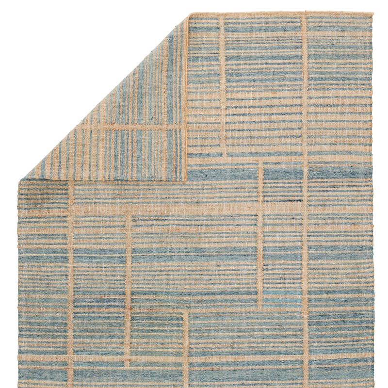 Dorada handwoven wool and jute rug with a blue and natural tan geometric grid pattern.