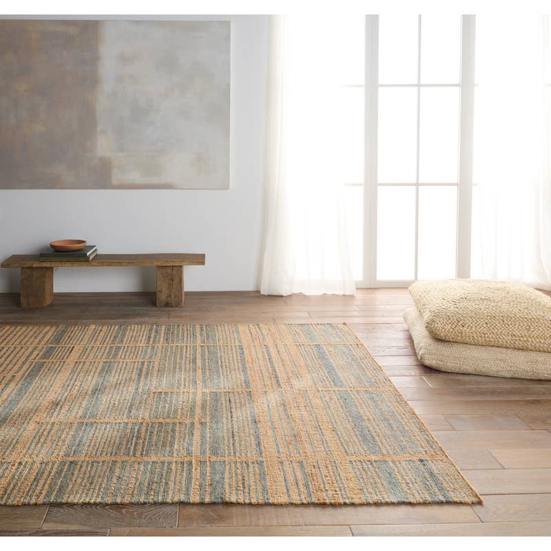 Dorada handwoven wool and jute rug with a blue and tan geometric pattern in a bright room