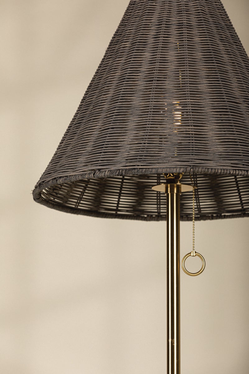 Destiny floor lamp with a gray woven wicker shade and aged brass pole and pull chain.