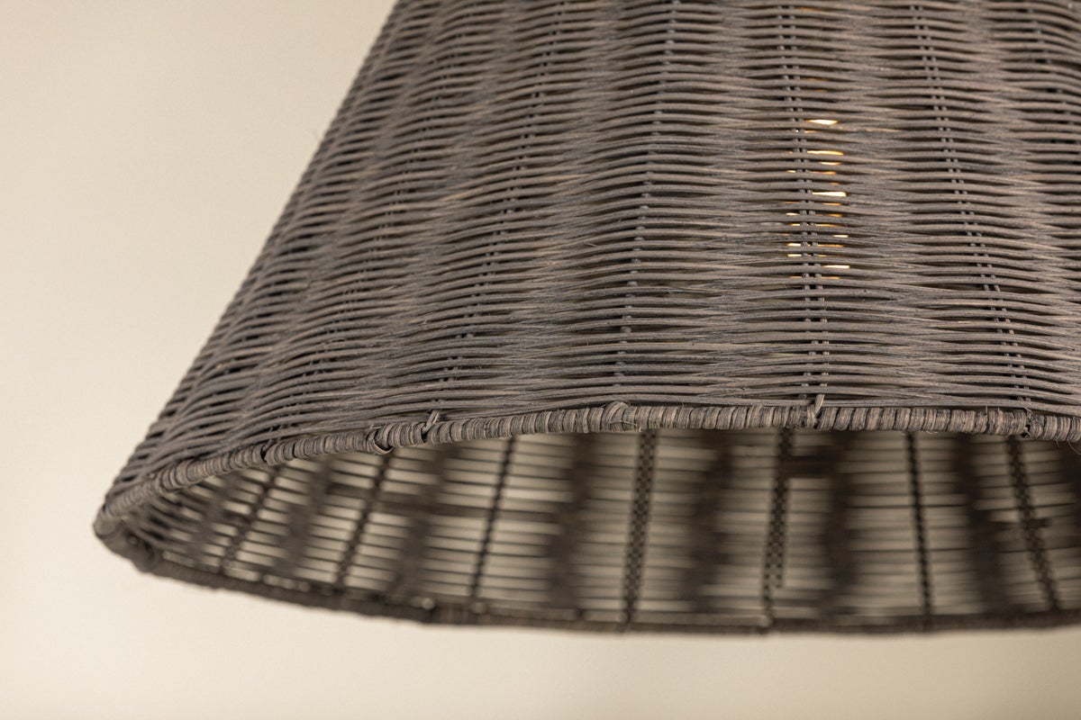 Destiny Pendant light featuring a woven gray wicker shade with a warm light glowing from within.