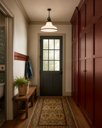 Teton wooden dining bench in a mudroom entryway with red cabinets