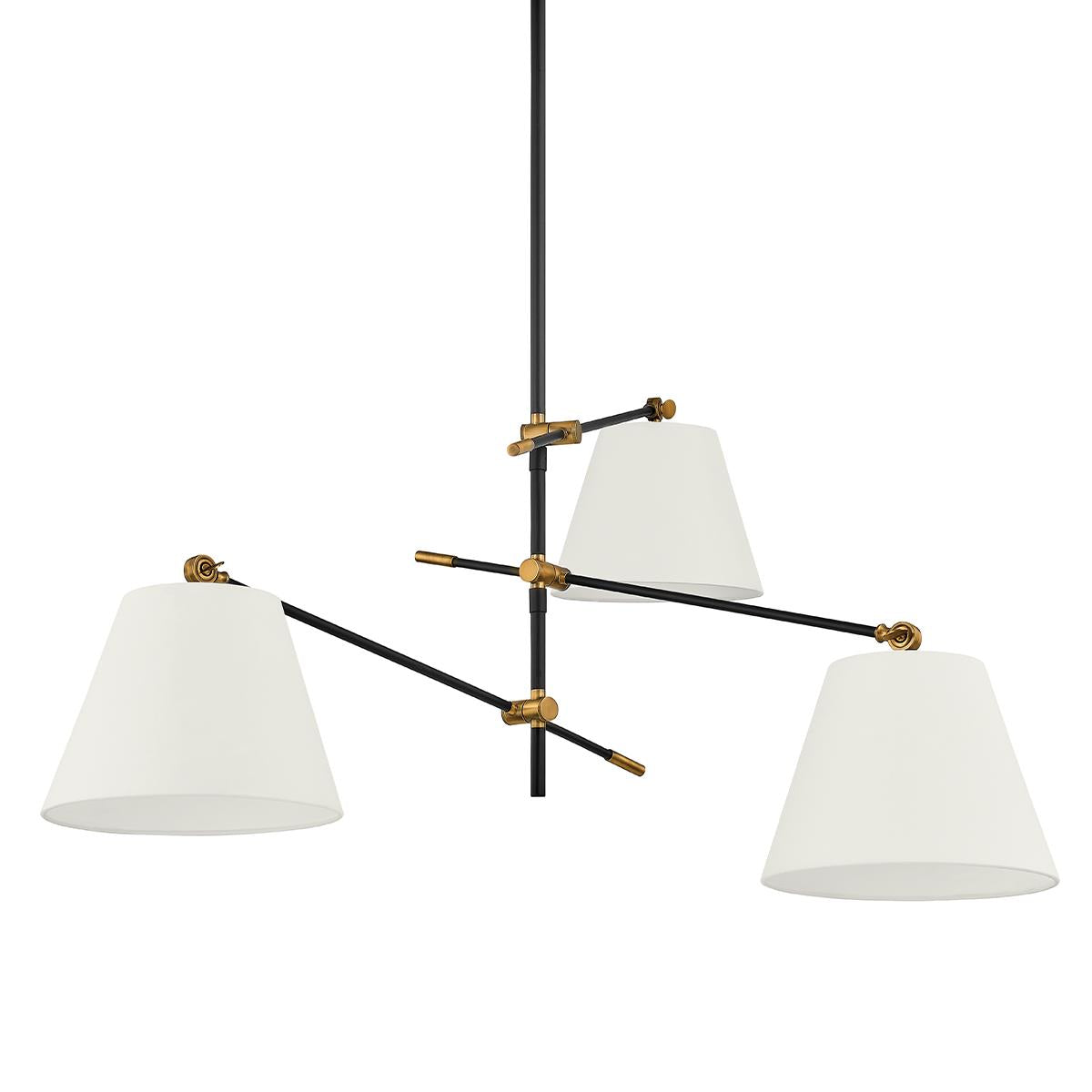 Navin Chandelier with black adjustable arms, brass accents, and three white linen shades.