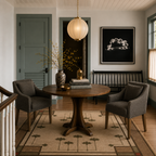 Ginkgo Beige Hand Knotted Wool Rug under a round wooden dining table and chairs.