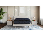 Dark blue Indulgence pillow top mattress on a modern white bed frame in a bedroom.