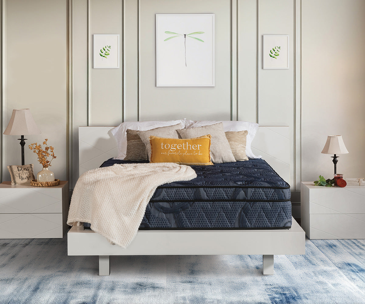 Opulence Eurotop mattress in dark blue patterned fabric on a white platform bed frame.