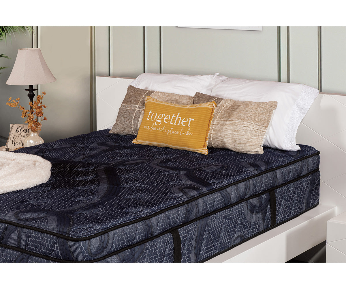 Opulence 13-inch Eurotop mattress in dark blue patterned fabric on a white bed frame