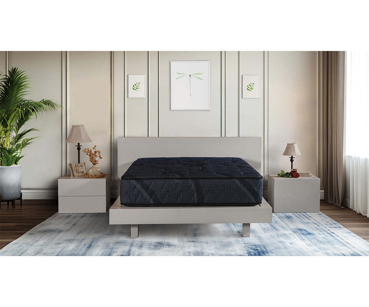 Splendor Mattress in dark blue quilted fabric on a modern light grey bed frame.