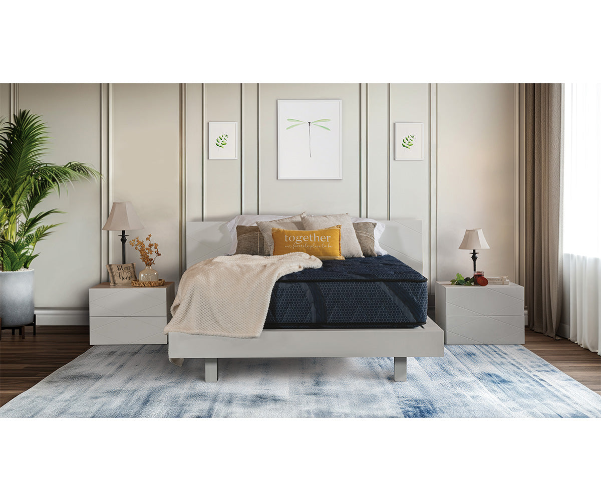 Splendor dark blue quilted mattress on a modern white bed frame in a styled bedroom.