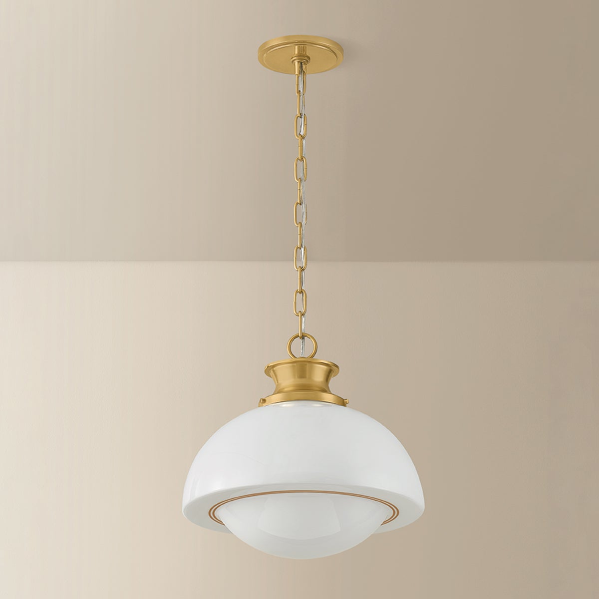 Celine mid-century pendant light with a white opal glass dome shade and gold chain suspension.