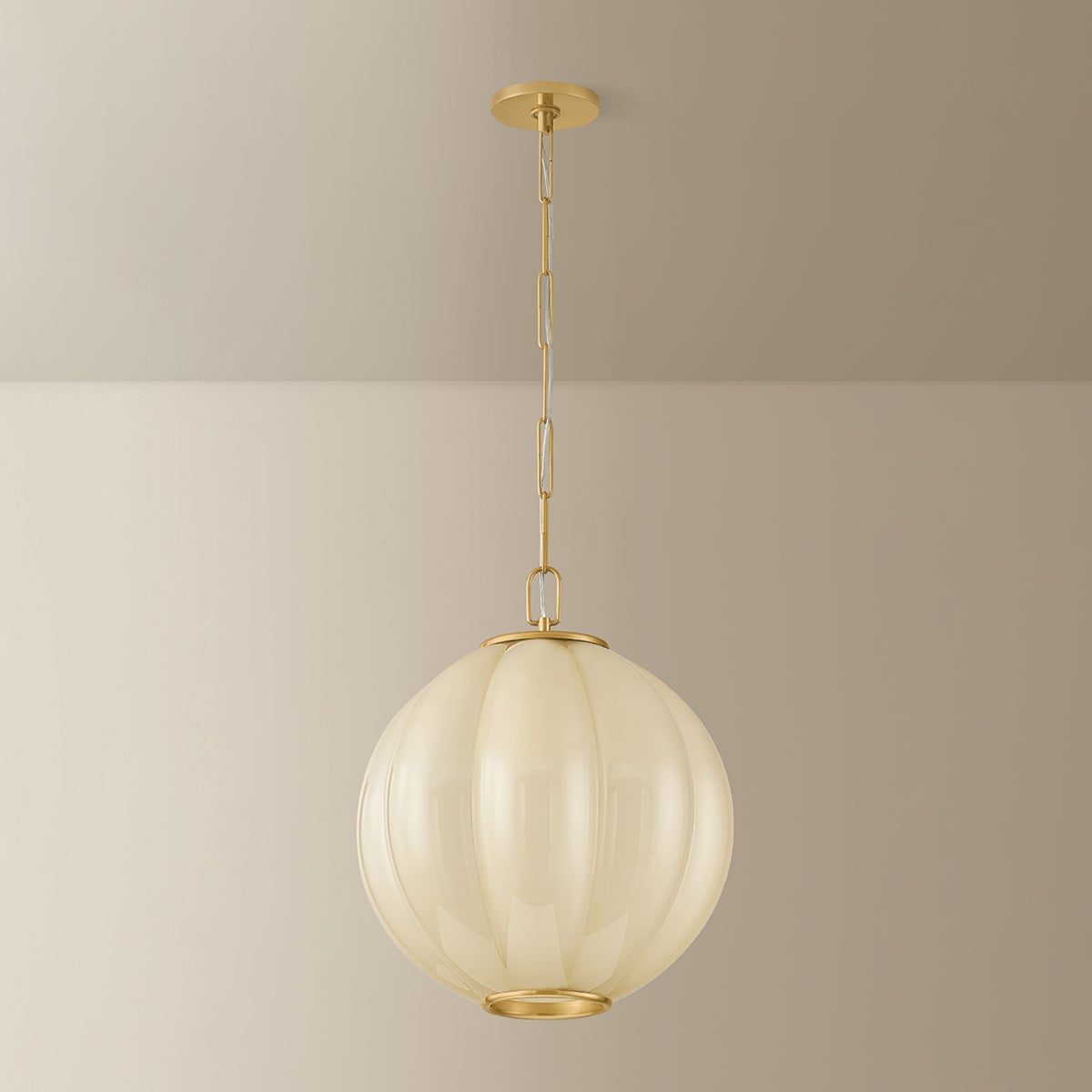 Bernadine pendant light with scalloped cream glass shade and aged brass chain hardware.