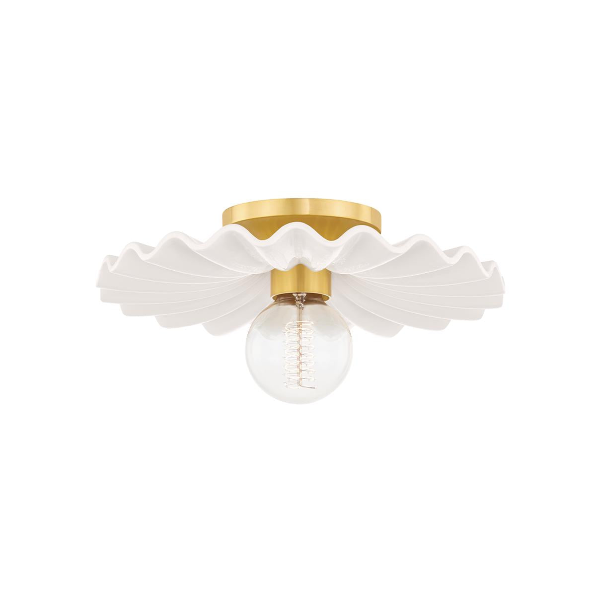 Tinsley flush mount light with ruffled white ceramic collar, aged brass hardware, and exposed globe bulb.