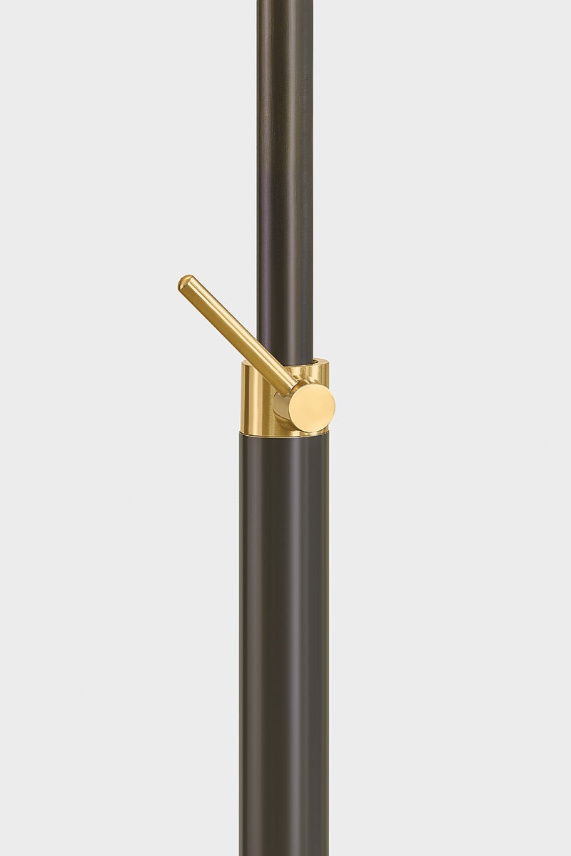 Aged Brass clutch swivel on the dark metal neck of the Harriet Floor Lamp.
