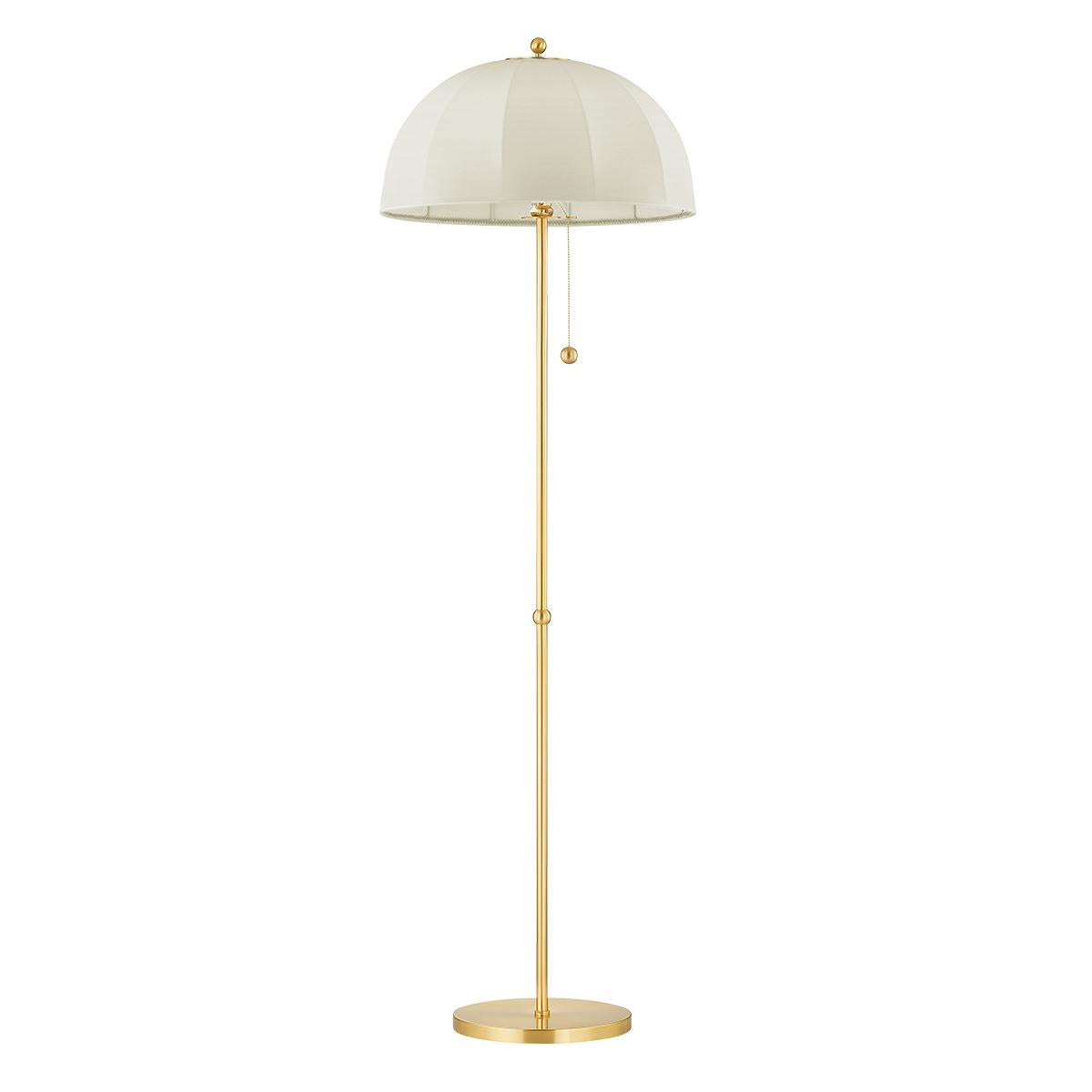Meshelle floor lamp with a cream umbrella shade and aged brass stand.