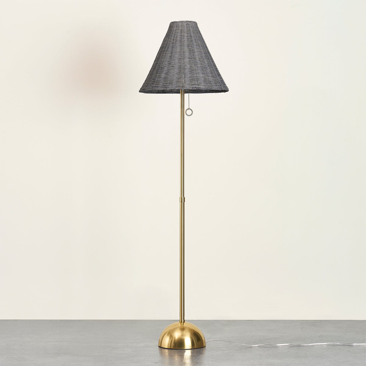 Destiny floor lamp with a gray wicker cone shade and aged brass base.