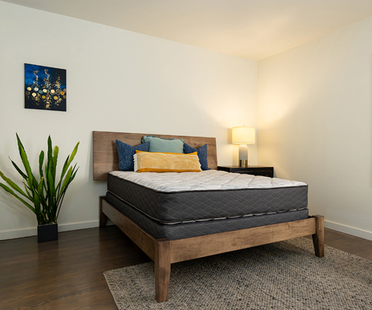 Sapphire Mattress with grey quilted sides on a wooden bed frame