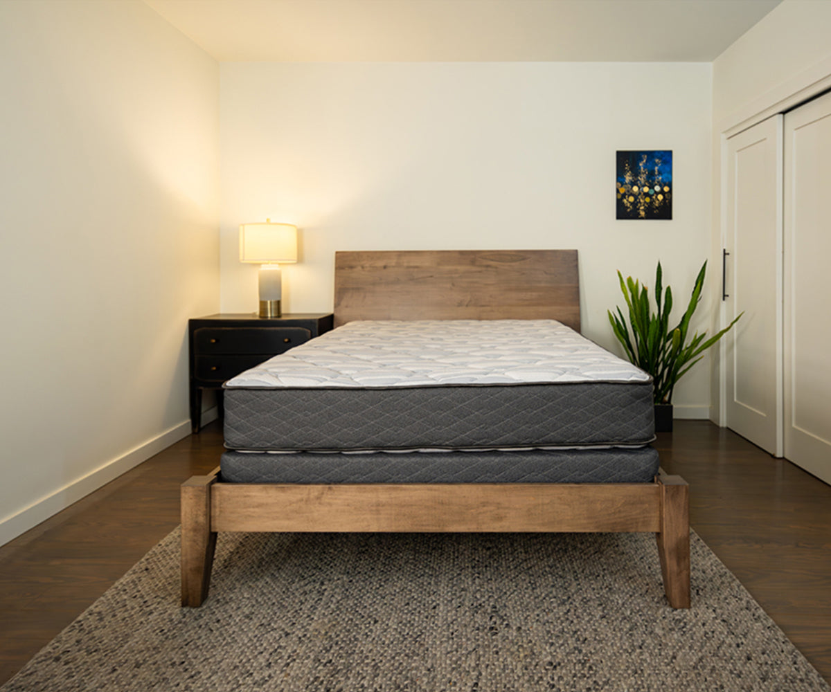 Sapphire Mattress with grey quilted sides on a wooden bed frame