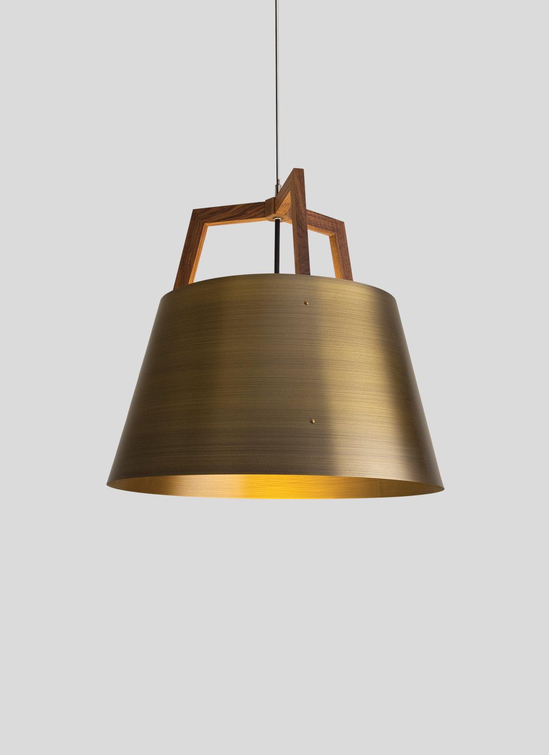 Imber Pendant light with a brushed brass shade and walnut wood accent.
