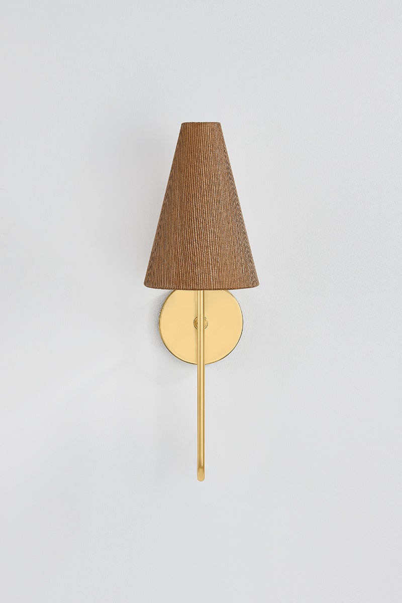 Jessel wall sconce with aged brass arm and brown grasscloth shade.