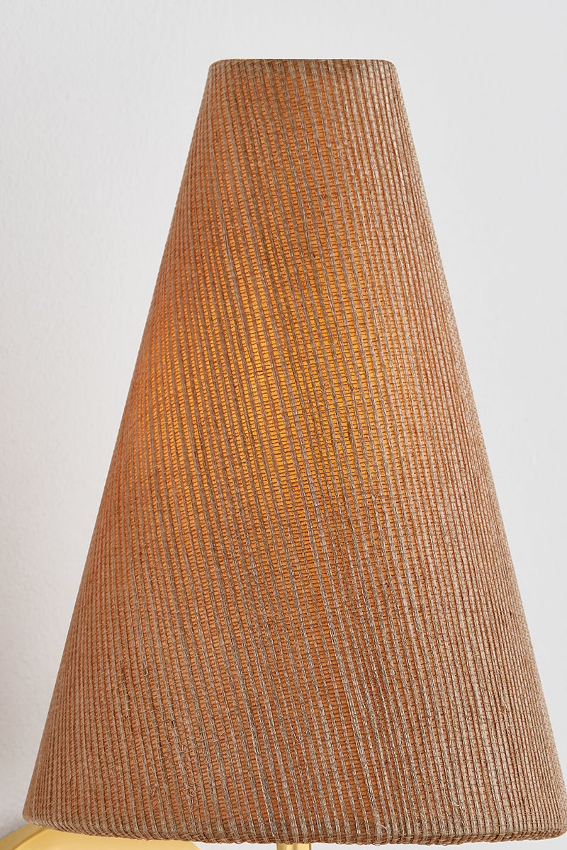 Jessel Wall Sconce with a textured, cone-shaped grasscloth shade emitting a warm glow.