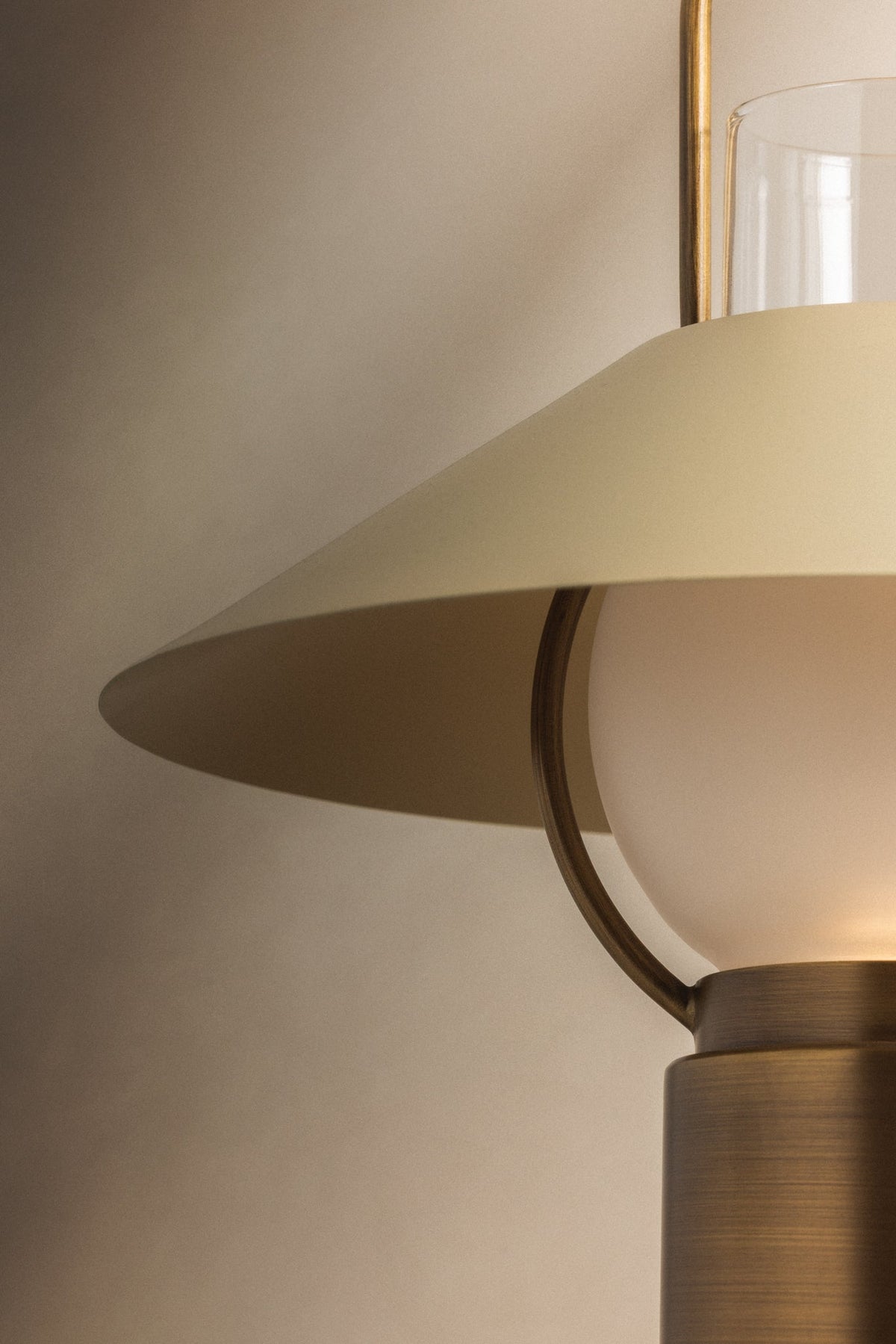Kindle table lamp with a soft sand tapered shade and patina brass metalwork.