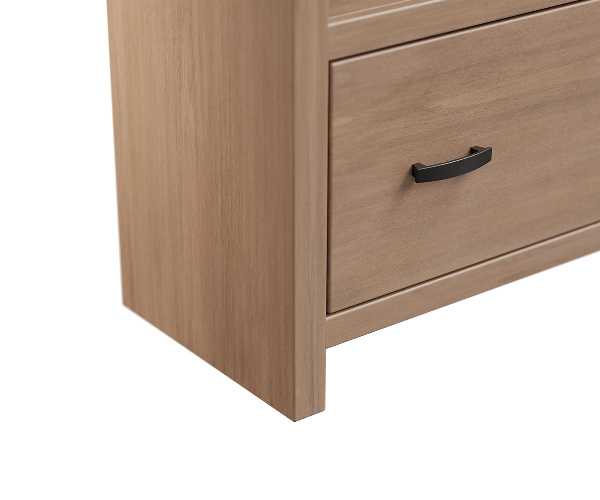 Close-up of a light brown wood bookcase drawer with a black metal handle.