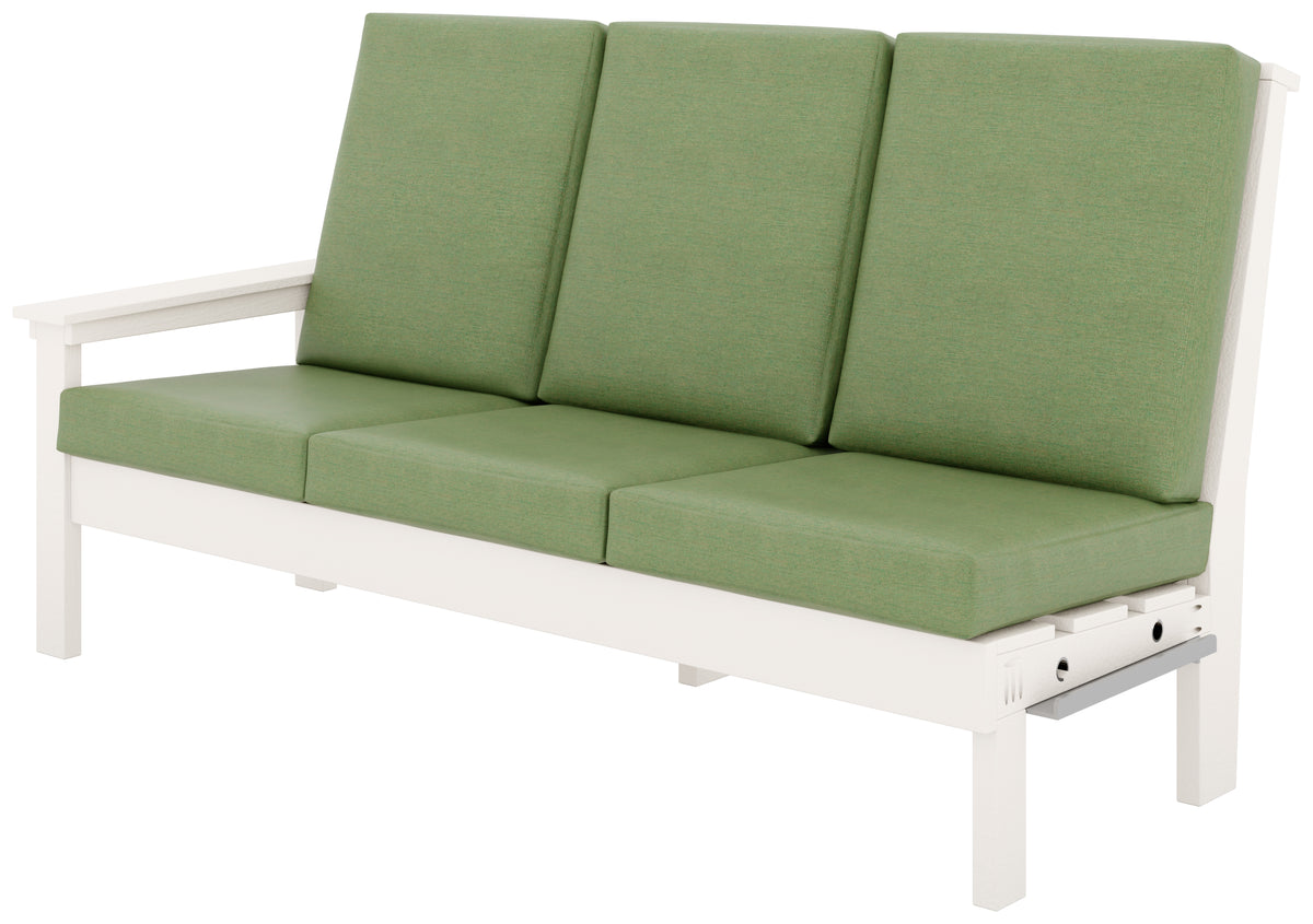 Contemporary white poly outdoor sofa with green canvas cushions.
