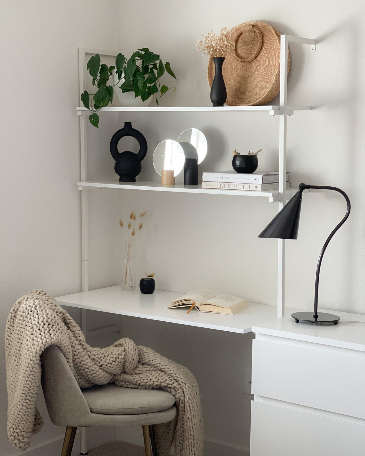 Lupe gooseneck table lamp in Old Bronze on a modern white desk with shelves