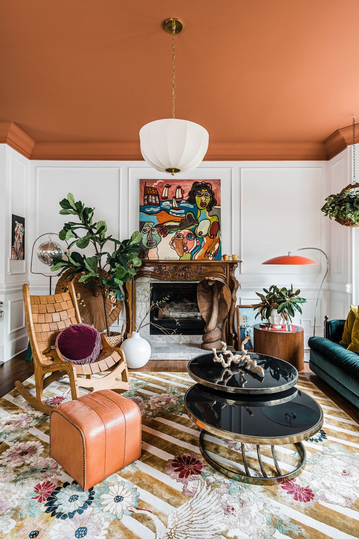 Meshelle white umbrella pendant light hanging from a terracotta ceiling in a maximalist living room.