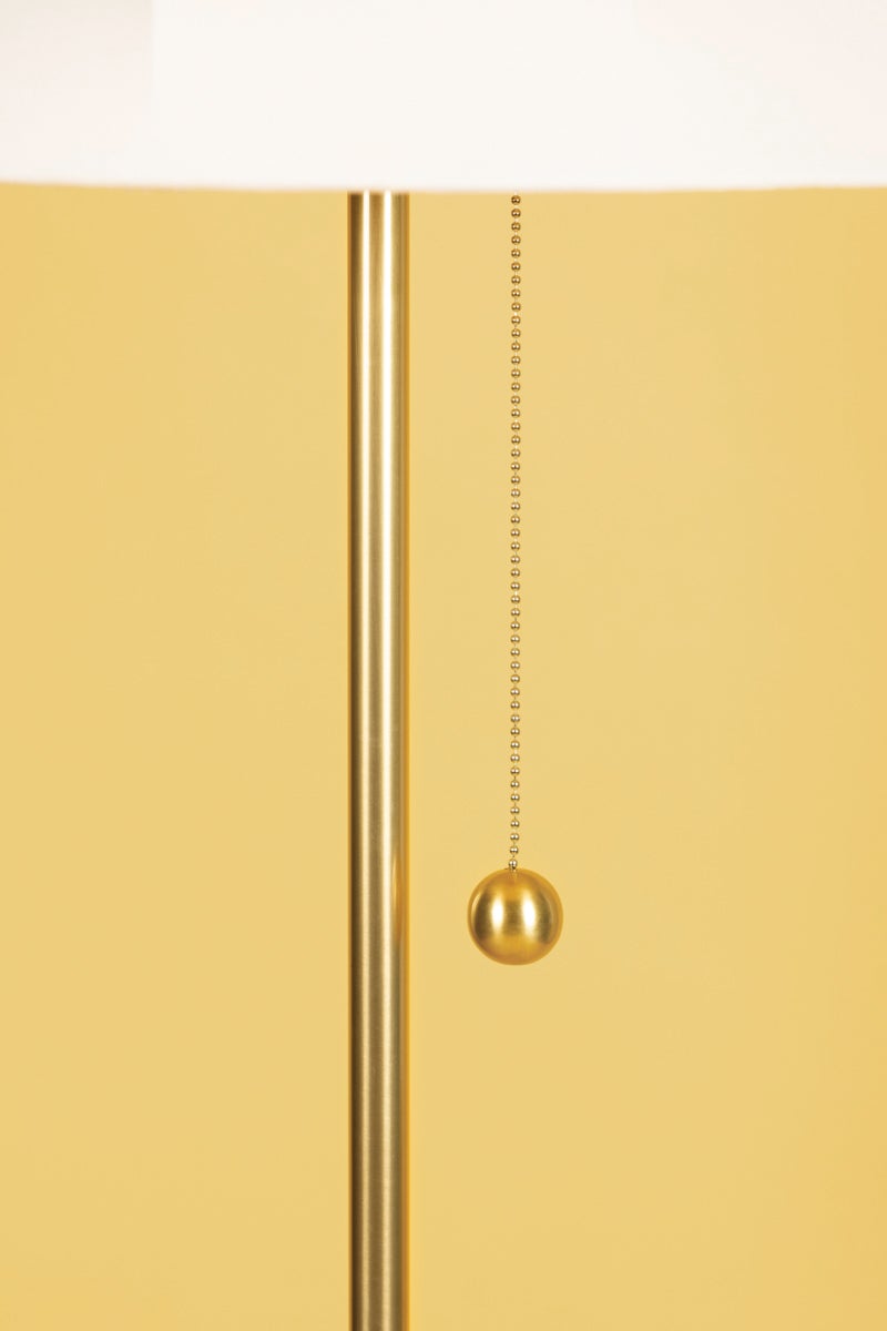 Aged brass pull chain with ball finial on the Meshelle floor lamp.