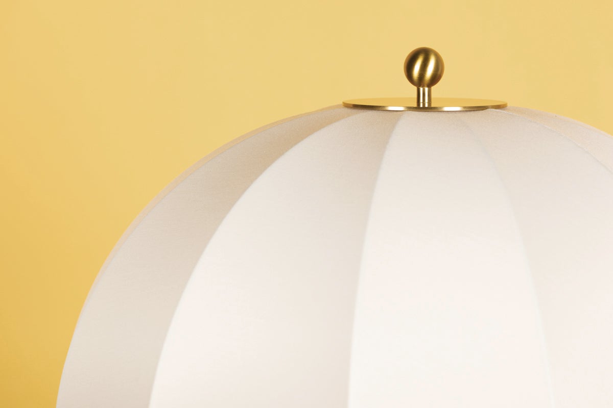 Meshelle floor lamp white umbrella shade with aged brass finial against yellow background