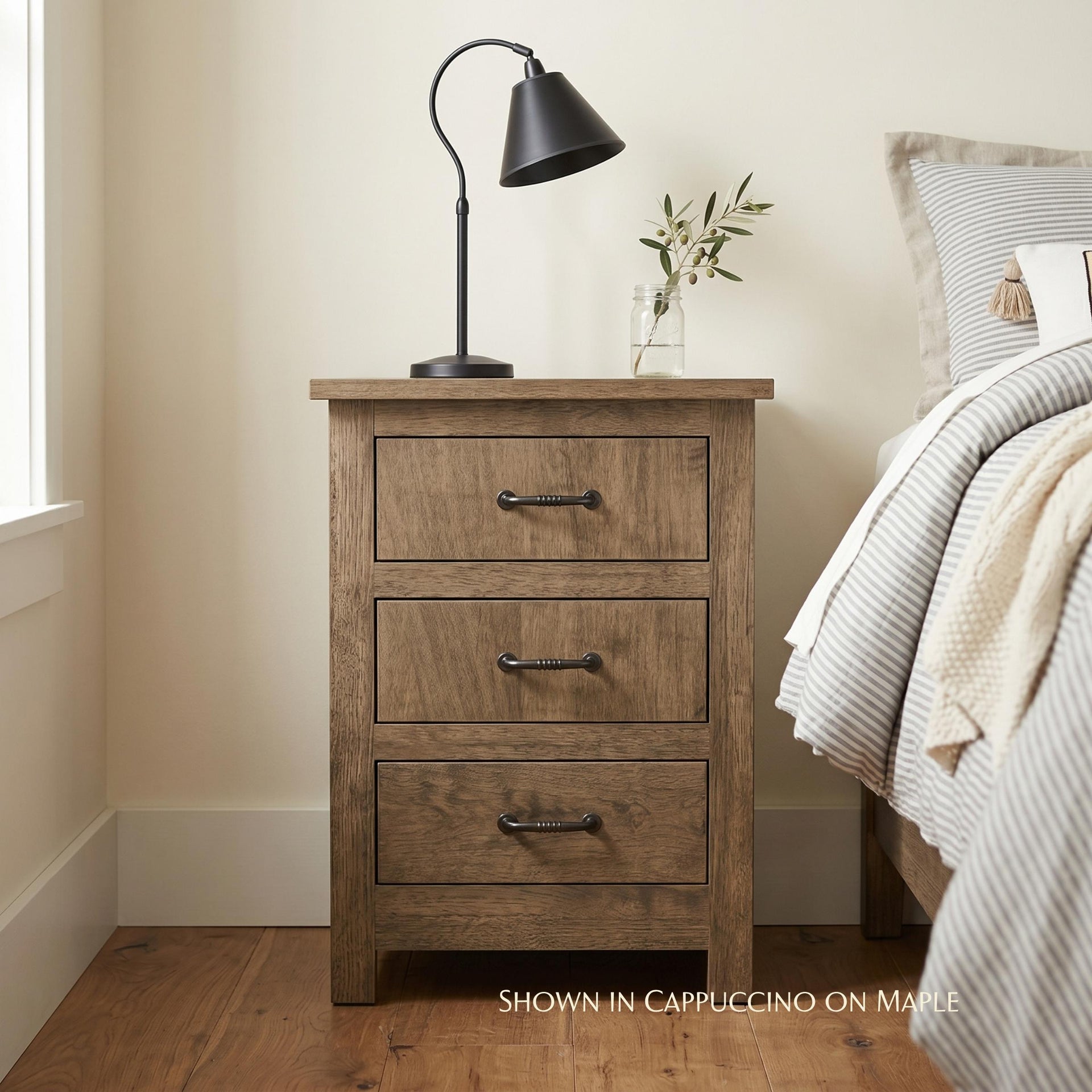 Mission narrow nightstand in cappuccino on maple wood with three drawers and dark metal handles.
