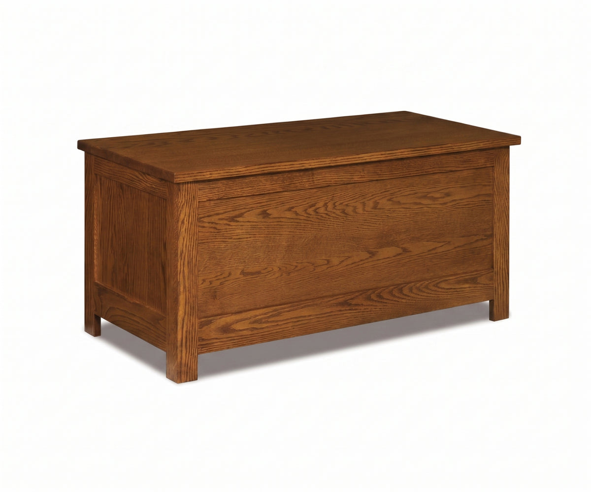 Mission style blanket chest in medium brown solid hardwood with visible oak wood grain.