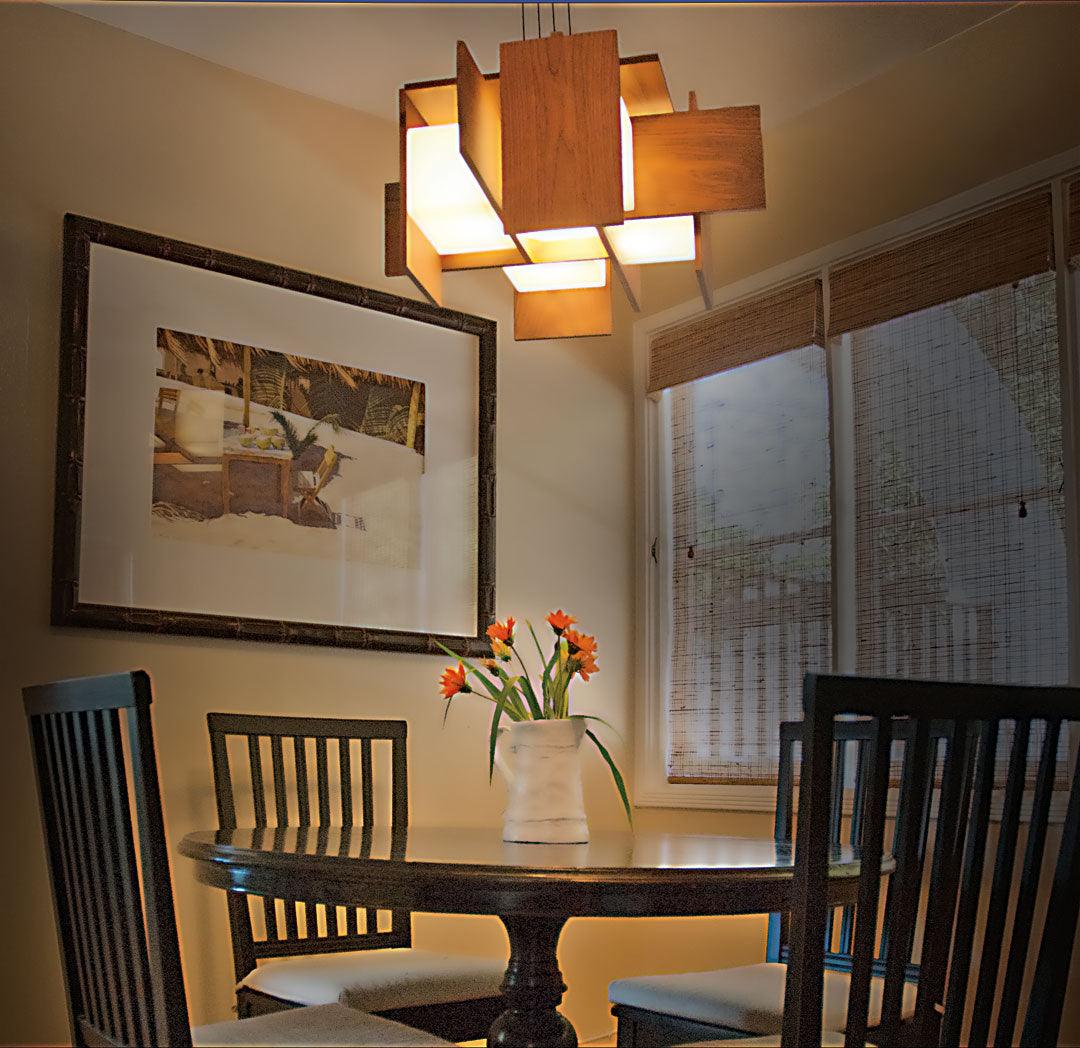 Muto walnut veneer pendant chandelier hanging over a dining table