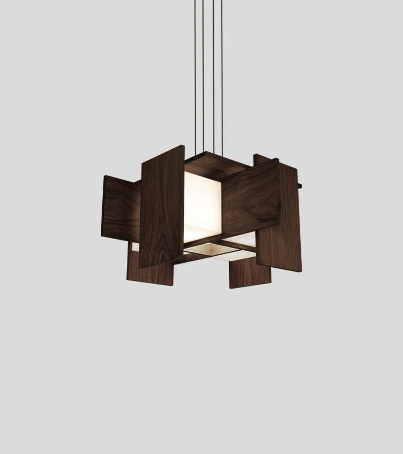 Muto pendant chandelier with floating walnut veneer panels and warm glowing LED light.