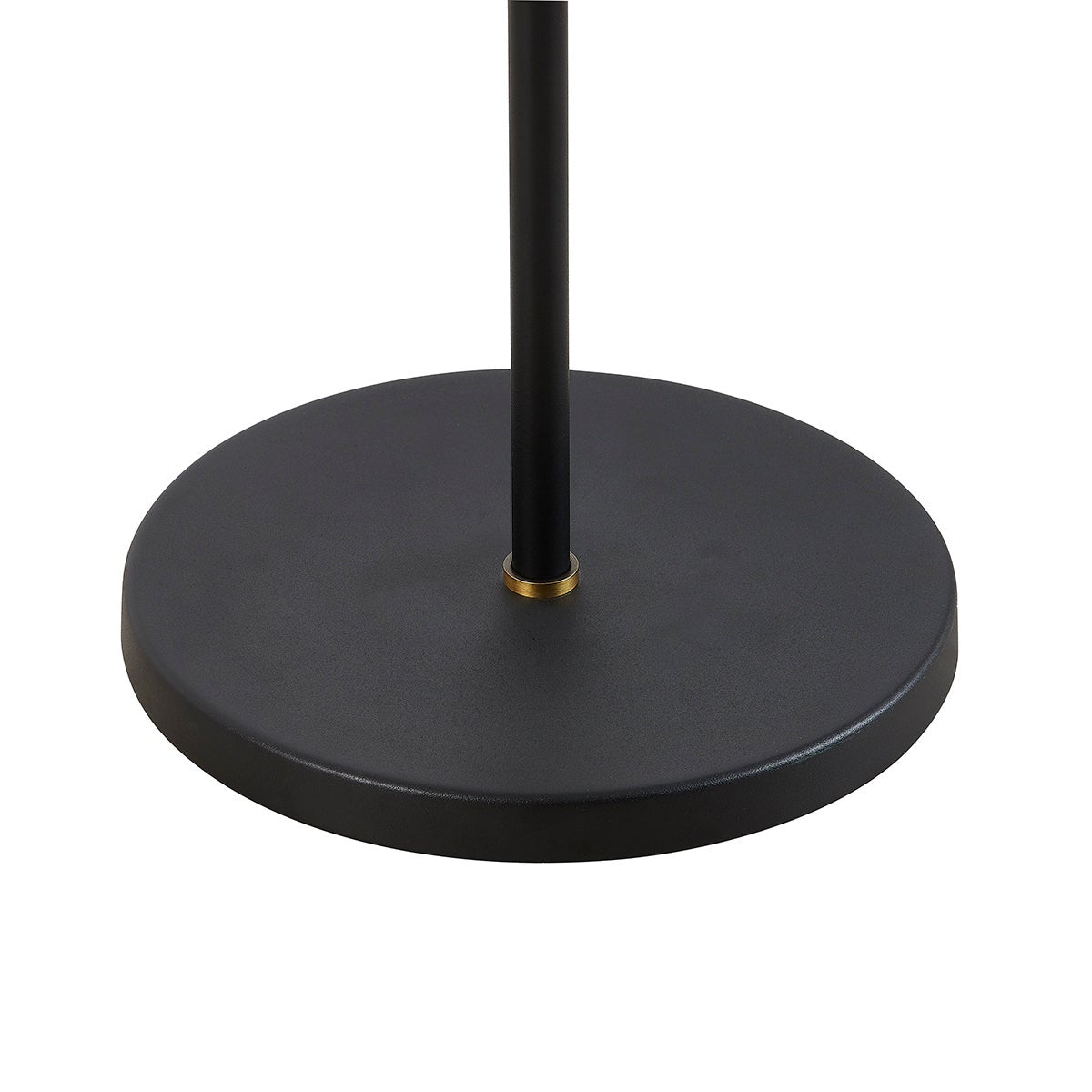 Textured black circular base of the Navin floor lamp with a brass collar accent.