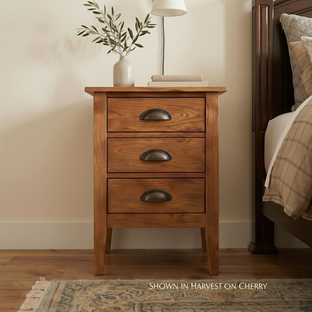 Nouvelle solid cherry wood nightstand with three drawers and bronze cup pulls.