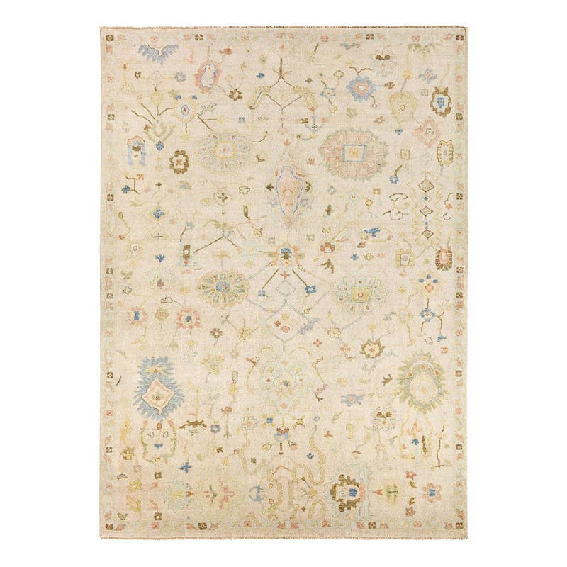 Orenda hand-knotted wool rug with muted floral patterns on a cream background.